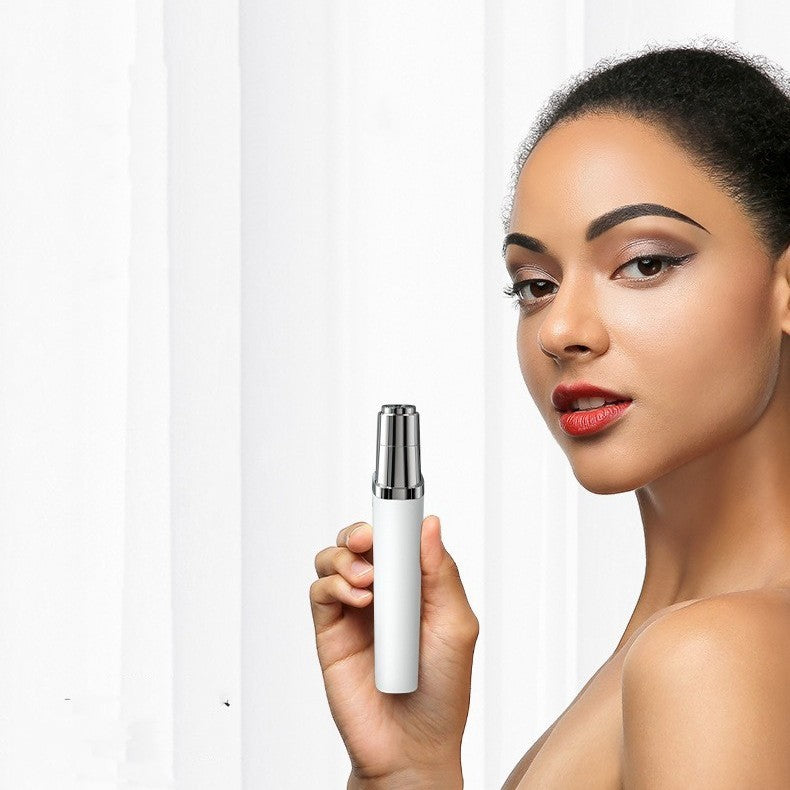 Woman holding a portable face hair trimmer in pearlescent white against a bright backdrop.